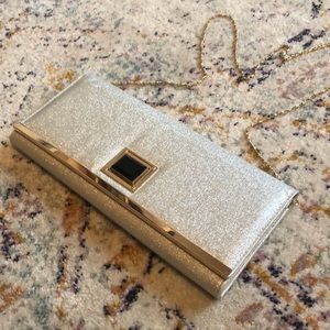 Silver metallic clutch with black & gold buckle!